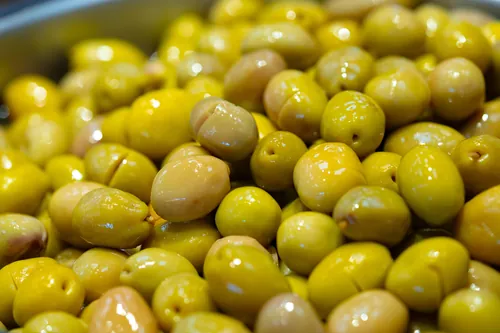 Aceitunas aliñadas expuestas en el mostrador de un puesto de mercado