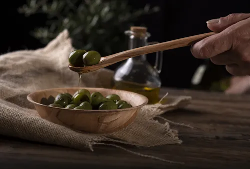 Persona sosteniendo una cuchara con aceite de oliva recién extraído