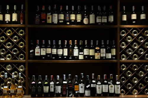 Barra de bar con botellas de vino al fondo desenfocado